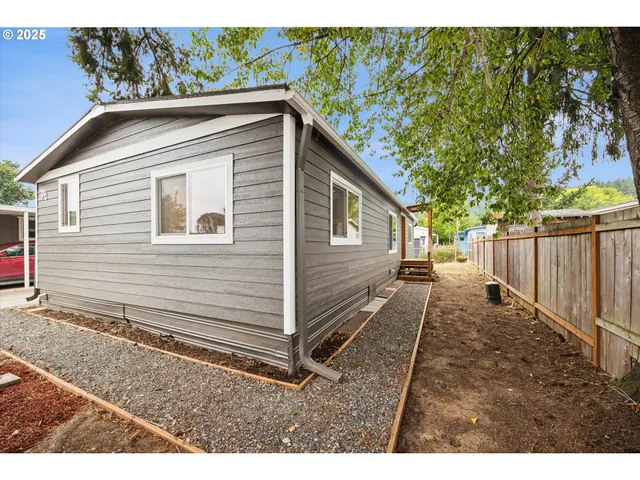 a street sign is sitting on a sidewalk