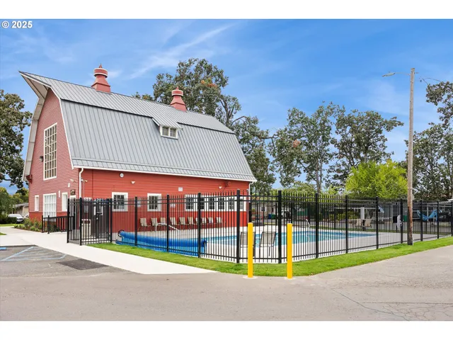 a kitchen with kitchen island a sink a stove a refrigerator and a window