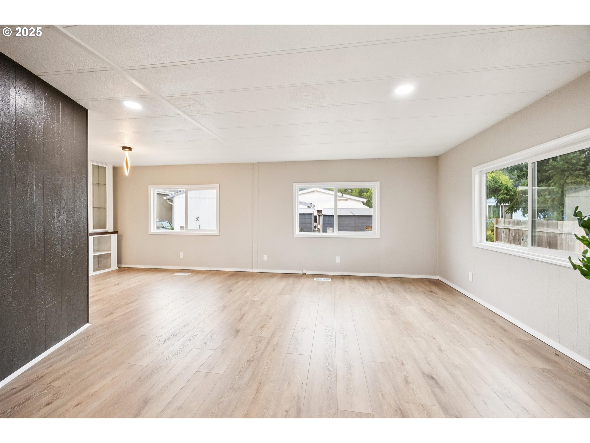 10701 Southeast Highway 212, Unit P6 Clackamas, OR 97015 - Photo 7 of 42 a view of an empty room with a window and wooden floor