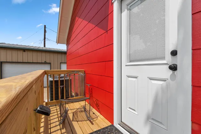 a view of a door and chair in the balcony