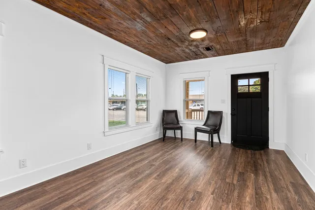 a work room with furniture and wooden floor