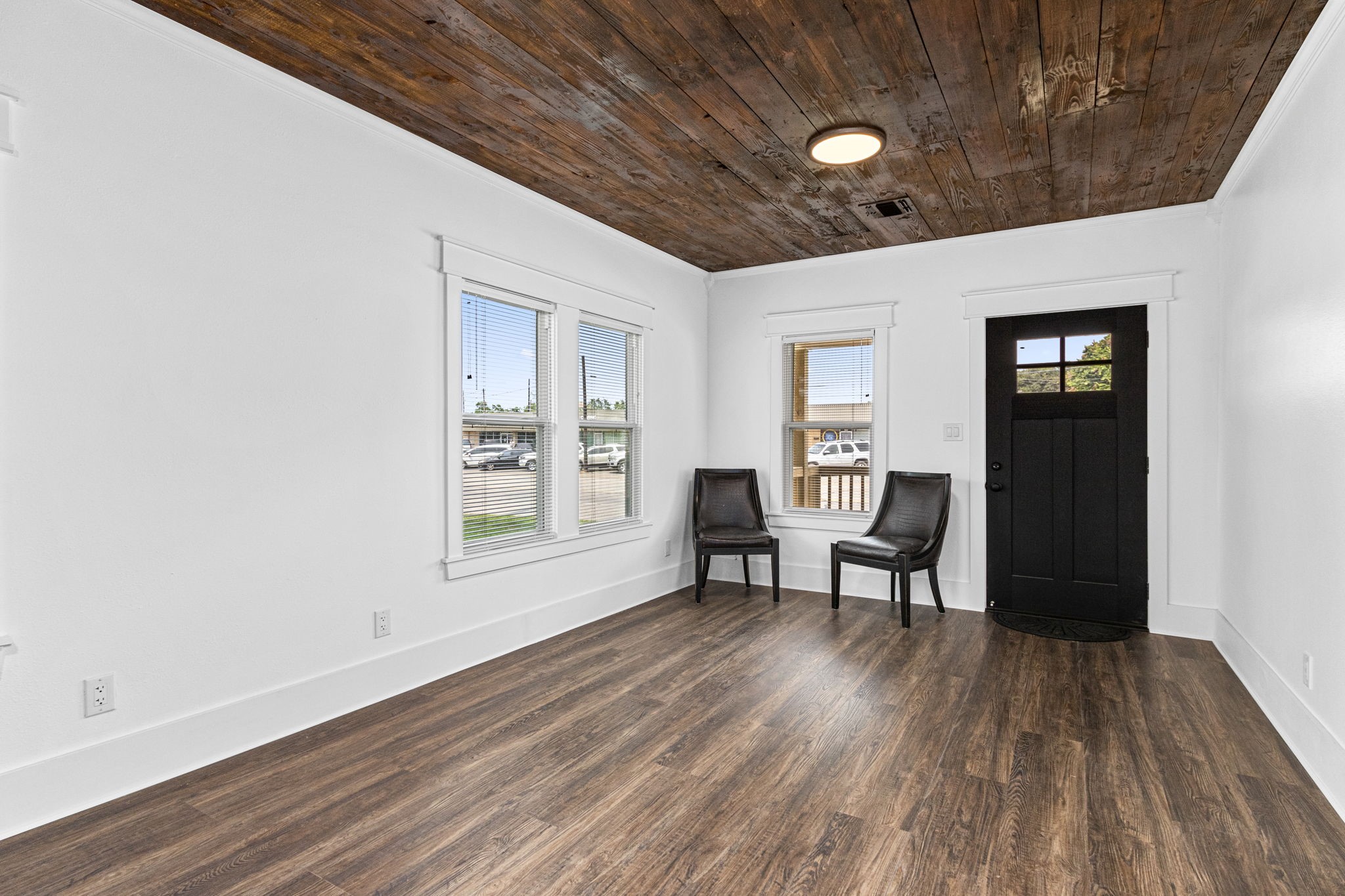 1138 Fannin Street Columbus, TX 78934 - Photo 2 of 25 a work room with furniture and wooden floor