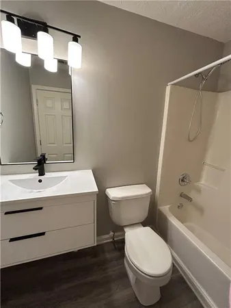a bathroom with a toilet a sink and bathtub