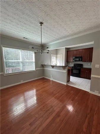 a view of a kitchen with a stove cabinets and wooden floor