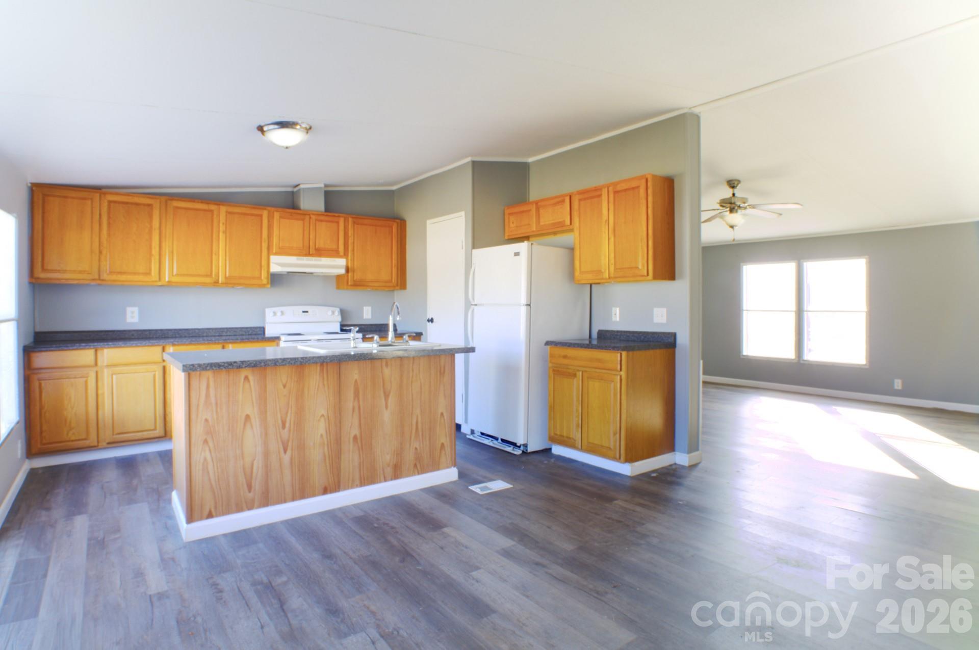4610 Deal Road Claremont, NC 28610 - Photo 13 of 13 a kitchen with wooden floors and cabinets