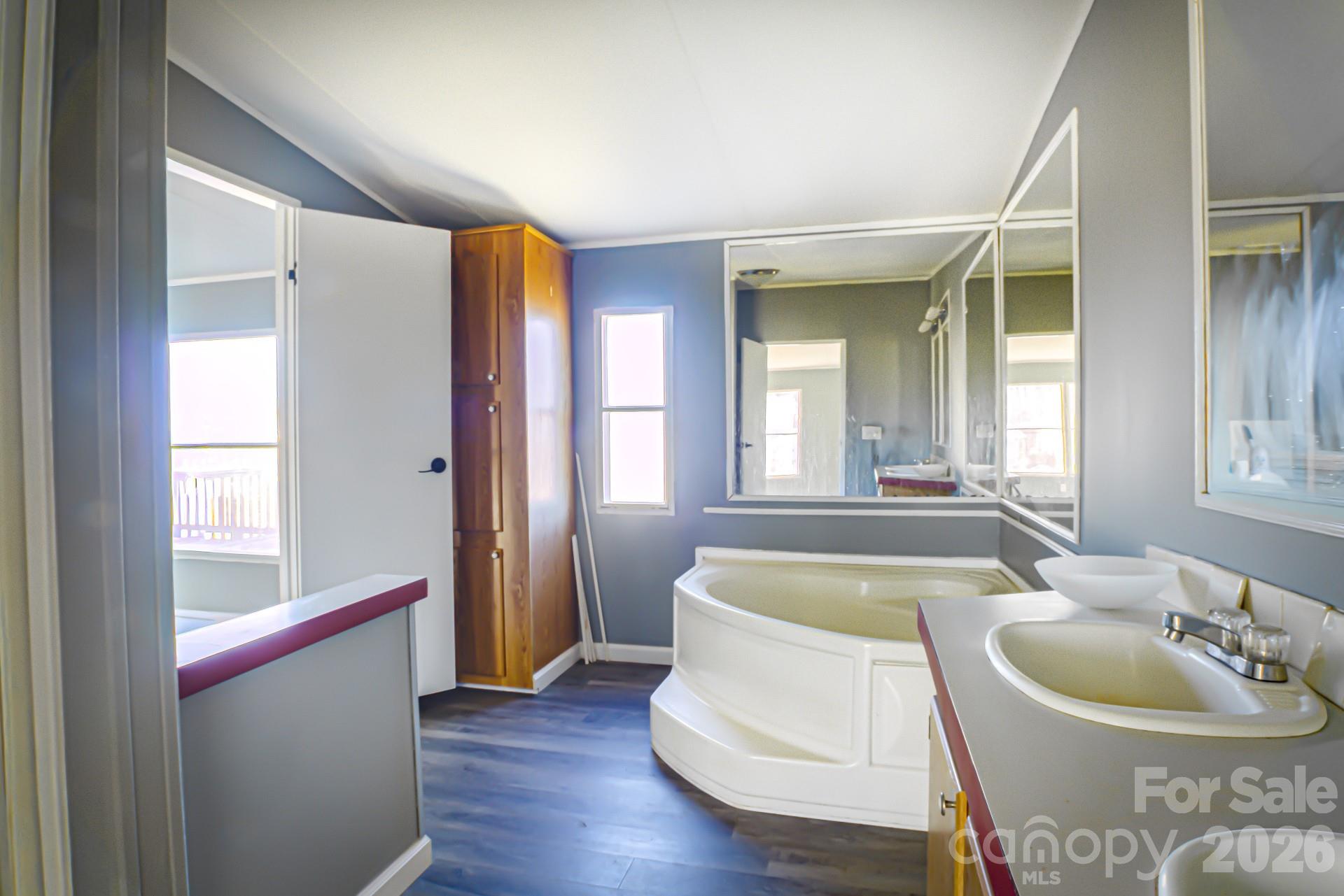 4610 Deal Road Claremont, NC 28610 - Photo 8 of 13 a bathroom with a tub sink and mirror