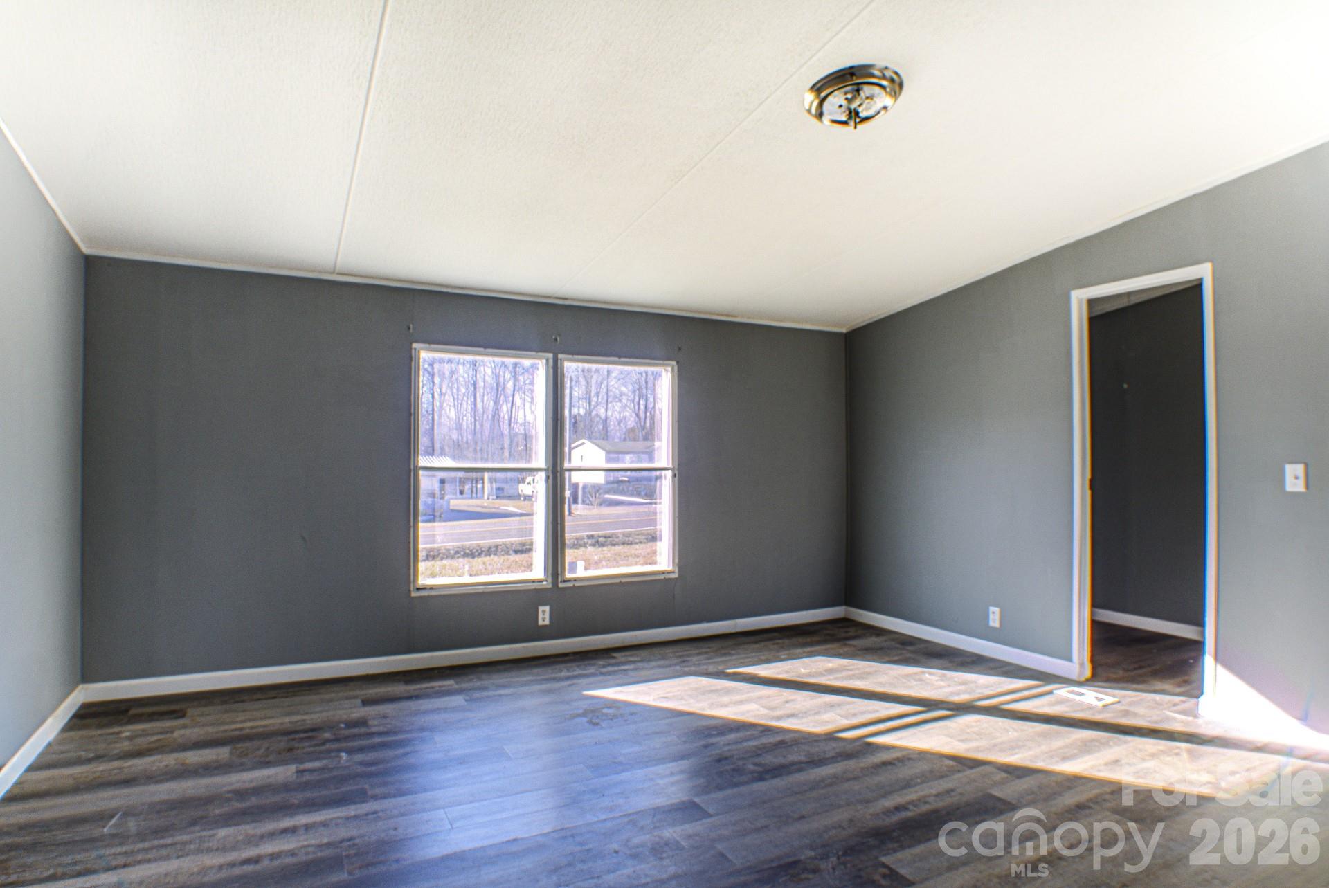 4610 Deal Road Claremont, NC 28610 - Photo 10 of 13 an empty room with wooden floor and windows