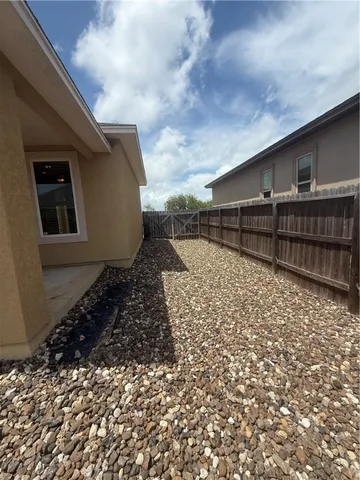 a backyard of a house with wooden fence