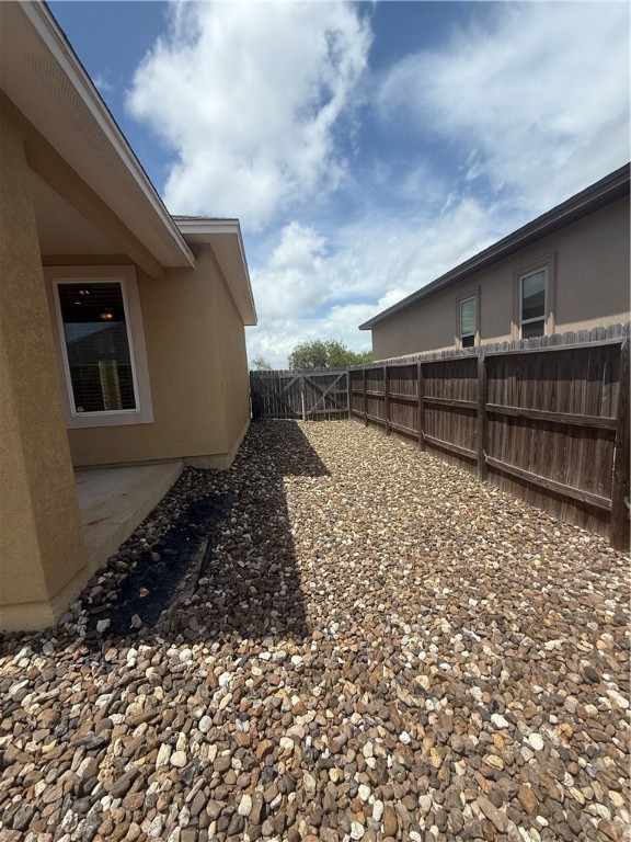 14510 Dragonet Street Corpus Christi, TX 78418 - Photo 18 of 19 a backyard of a house with wooden fence