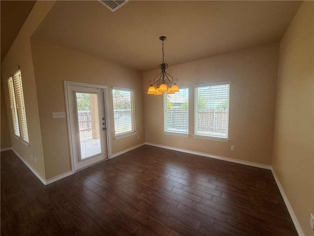 14510 Dragonet Street Corpus Christi, TX 78418 - Photo 6 of 19 a view of an empty room with wooden floor and a window