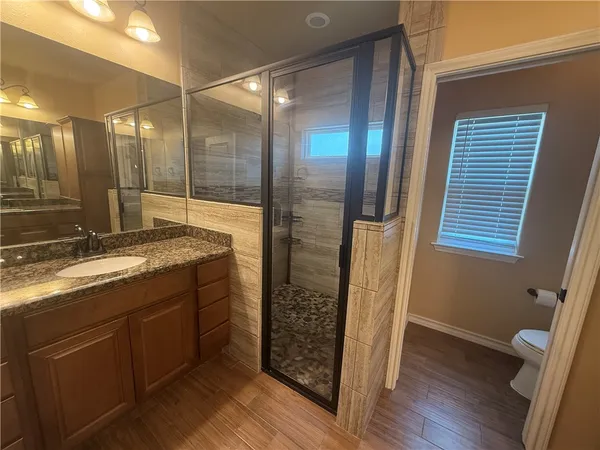 a bathroom with double vanity and a shower