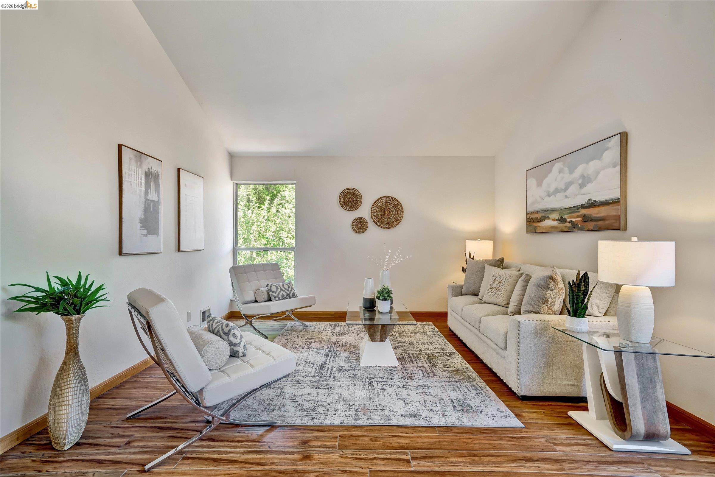 2826 Wright Avenue Pinole, CA 94564 - Photo 35 of 70 Bright living area featuring wood-finish flooring, a large window, a decorative ceiling, light wall finishes, and a contemporary aesthetic