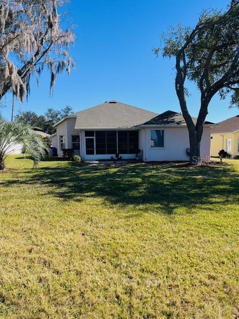 5685 Gulf Stream Street Tavares, FL 32778 - Photo 2 of 13 a front view of a house with a yard