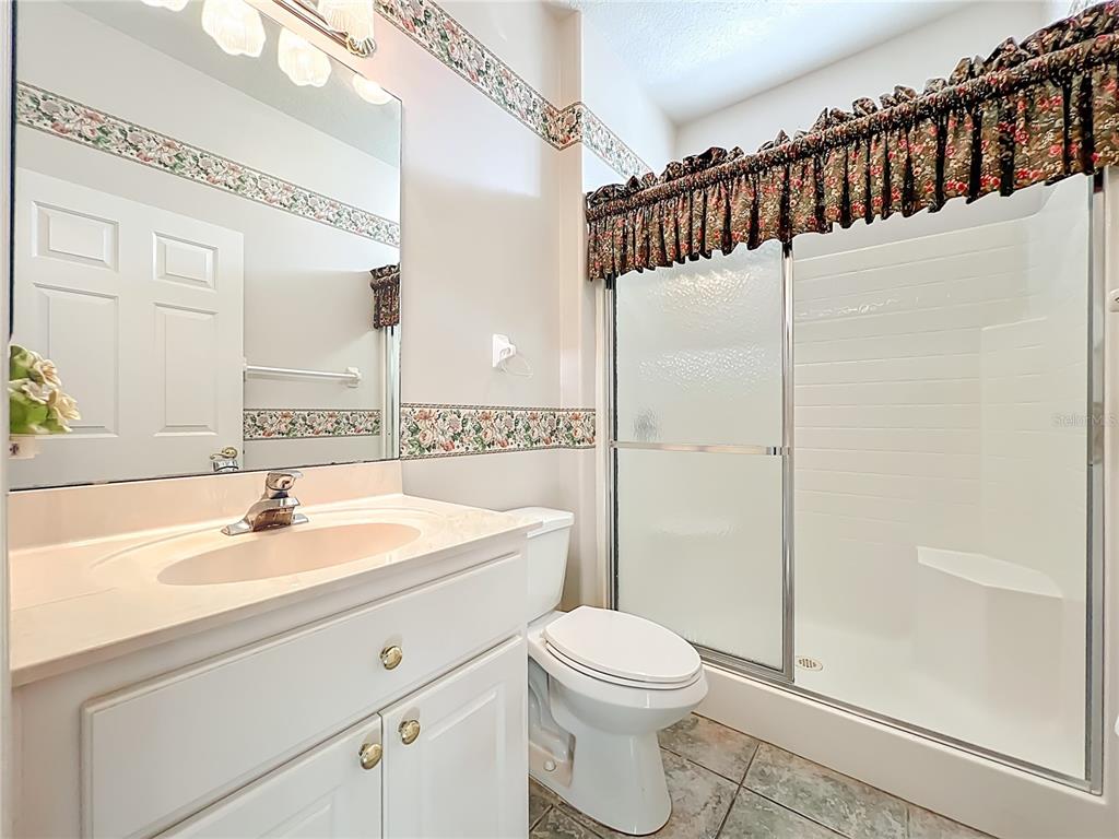 5685 Gulf Stream Street Tavares, FL 32778 - Photo 29 of 78 a bathroom with a sink a toilet and shower