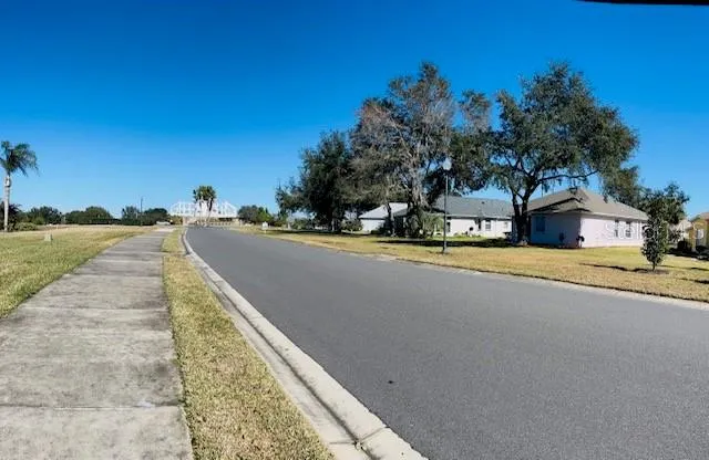 a view of swimming pool with outdoor seating and house in the background