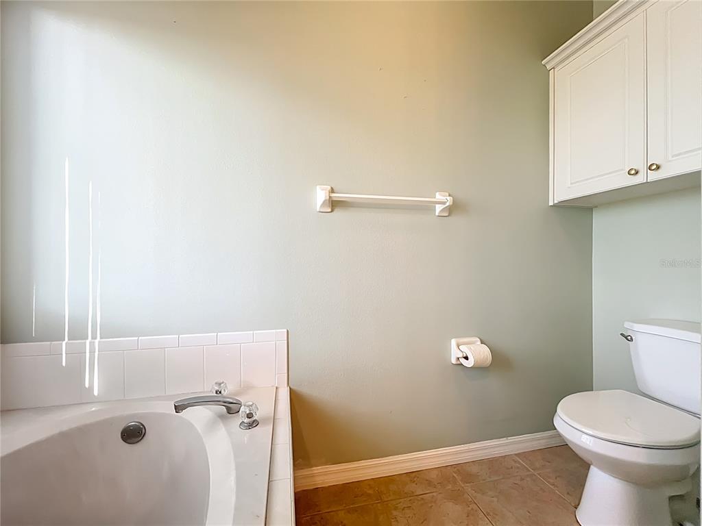 5685 Gulf Stream Street Tavares, FL 32778 - Photo 35 of 78 a bathroom with a toilet and a sink