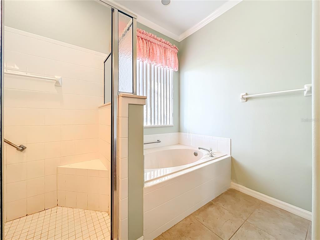 5685 Gulf Stream Street Tavares, FL 32778 - Photo 36 of 78 a bathroom with a bathtub and a shower
