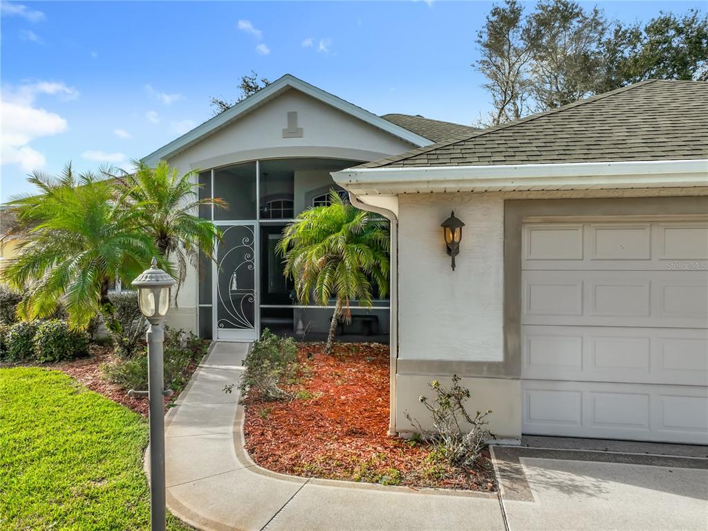 5685 Gulf Stream Street Tavares, FL 32778 - Photo 4 of 78 a front view of a house with garden