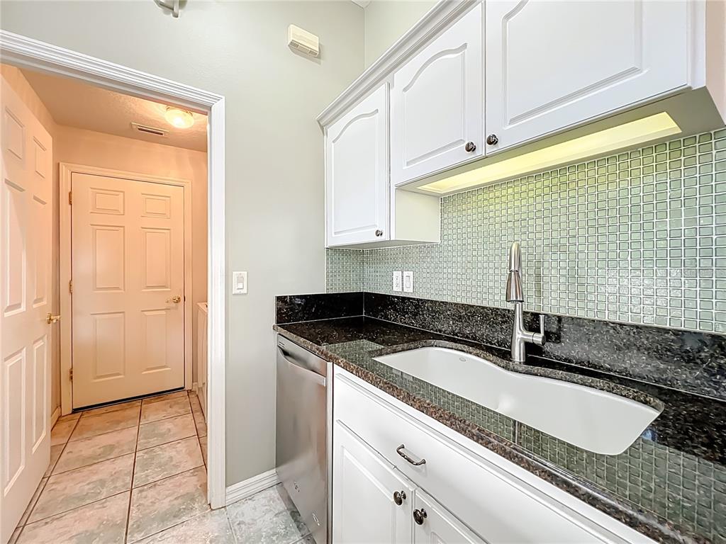 5685 Gulf Stream Street Tavares, FL 32778 - Photo 47 of 78 a kitchen with granite countertop a sink and a stove