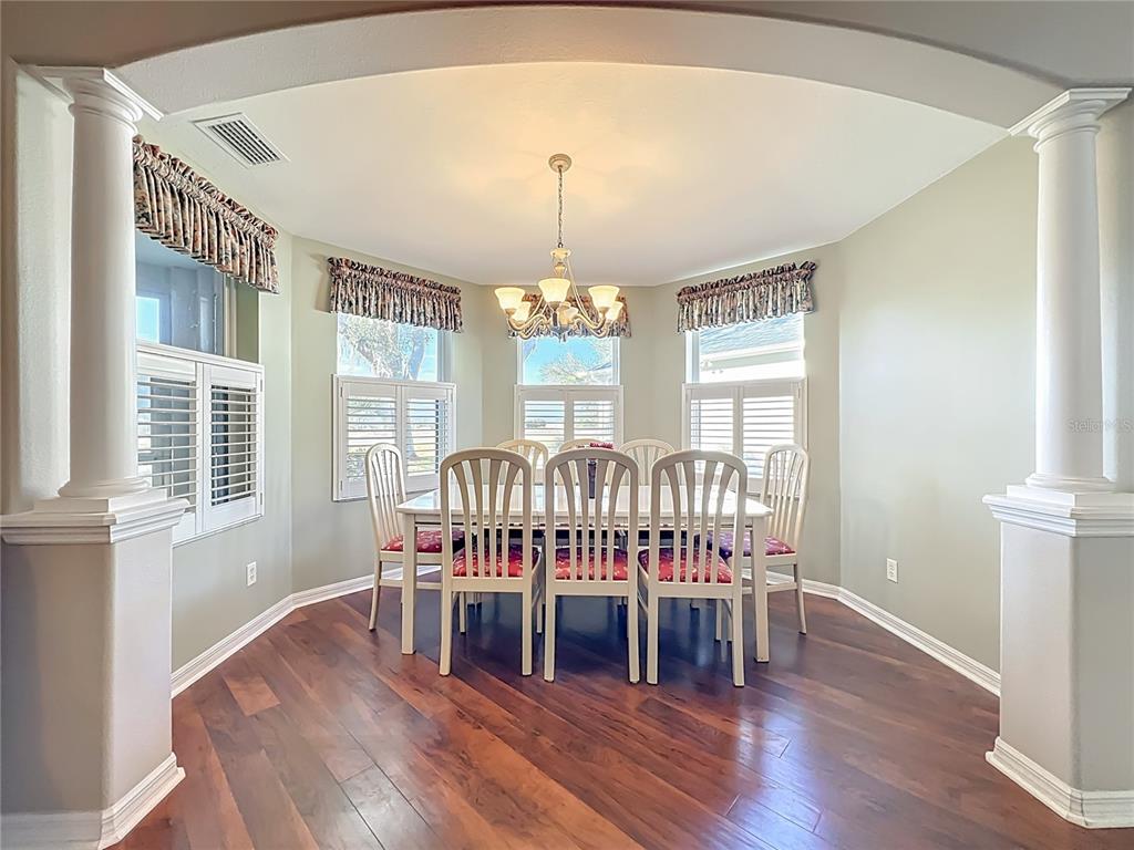 5685 Gulf Stream Street Tavares, FL 32778 - Photo 54 of 78 a view of a dining room with furniture window and wooden floor