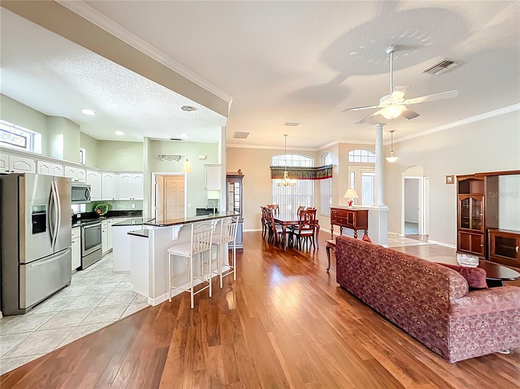 5685 Gulf Stream Street Tavares, FL 32778 - Photo 56 of 78 a living room with stainless steel appliances kitchen island granite countertop furniture and a kitchen view