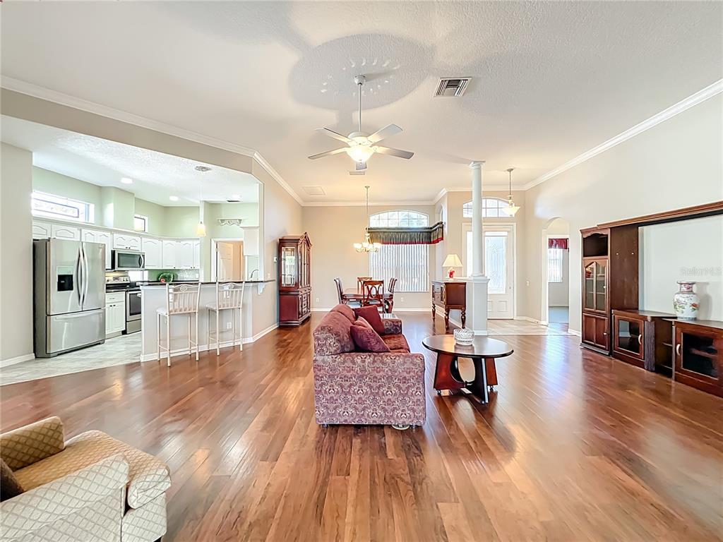 5685 Gulf Stream Street Tavares, FL 32778 - Photo 58 of 78 a living room with furniture and wooden floor