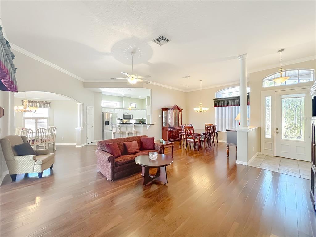 5685 Gulf Stream Street Tavares, FL 32778 - Photo 59 of 78 a living room with furniture and a wooden floor