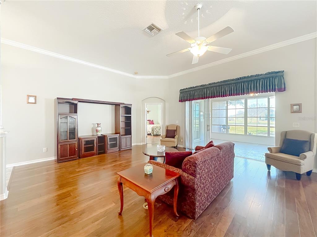 5685 Gulf Stream Street Tavares, FL 32778 - Photo 61 of 78 a living room with furniture and wooden floor