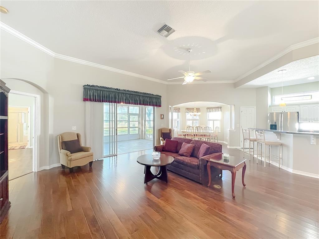 5685 Gulf Stream Street Tavares, FL 32778 - Photo 62 of 78 a living room with furniture and wooden floor