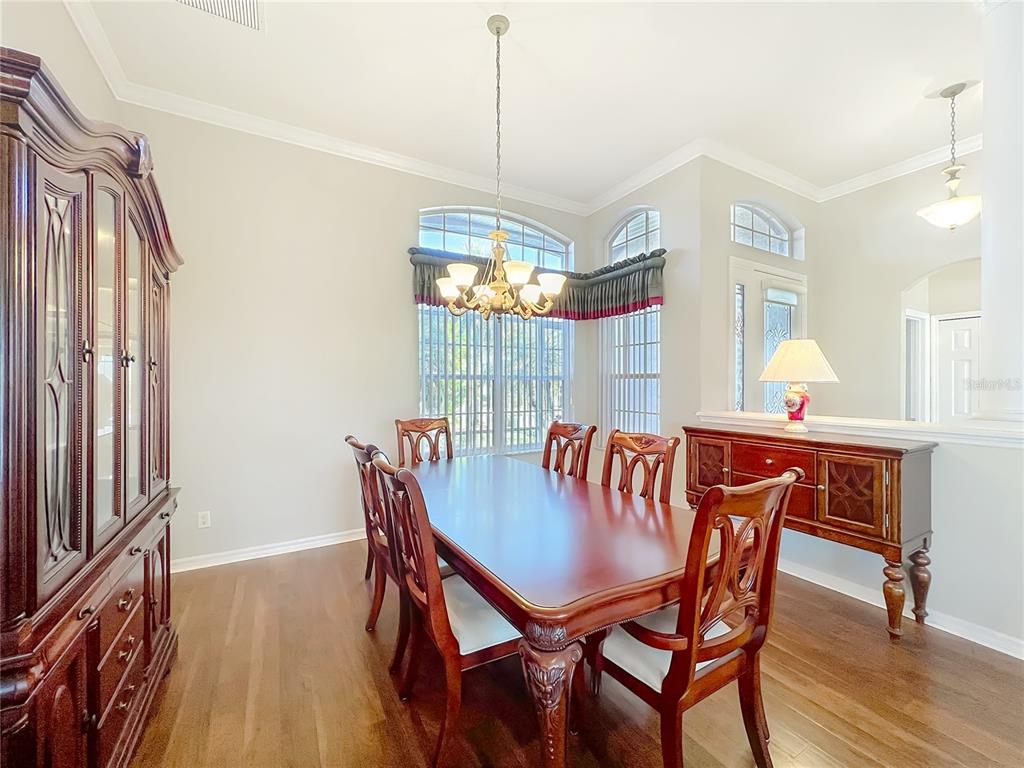 5685 Gulf Stream Street Tavares, FL 32778 - Photo 63 of 78 a view of a dining room with furniture window and wooden floor