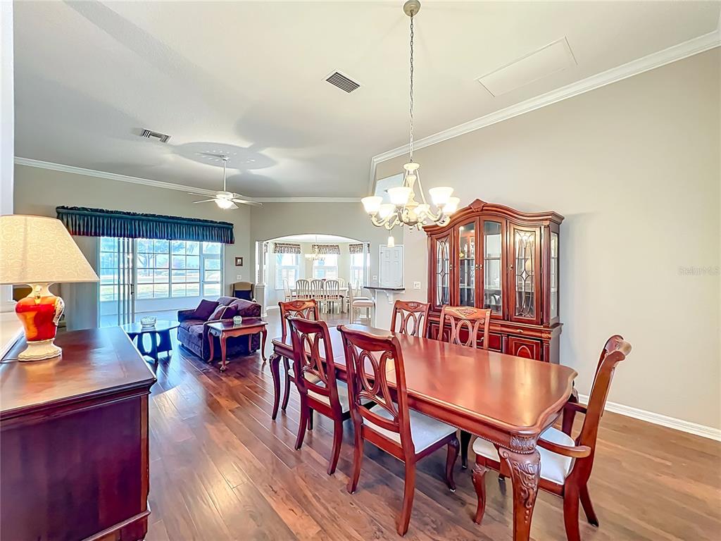 5685 Gulf Stream Street Tavares, FL 32778 - Photo 64 of 78 a view of a dining room with furniture window and wooden floor
