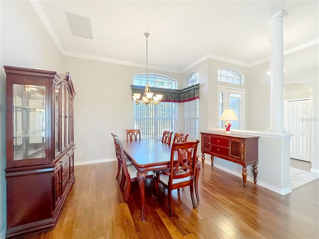 5685 Gulf Stream Street Tavares, FL 32778 - Photo 66 of 78 a view of a dining room with furniture window and wooden floor