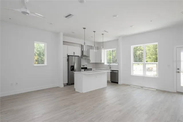 a kitchen with a refrigerator and a stove top oven