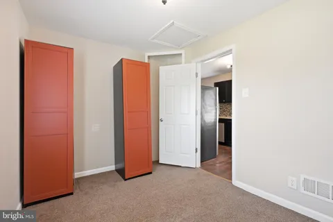 an empty room with closet and wooden floor
