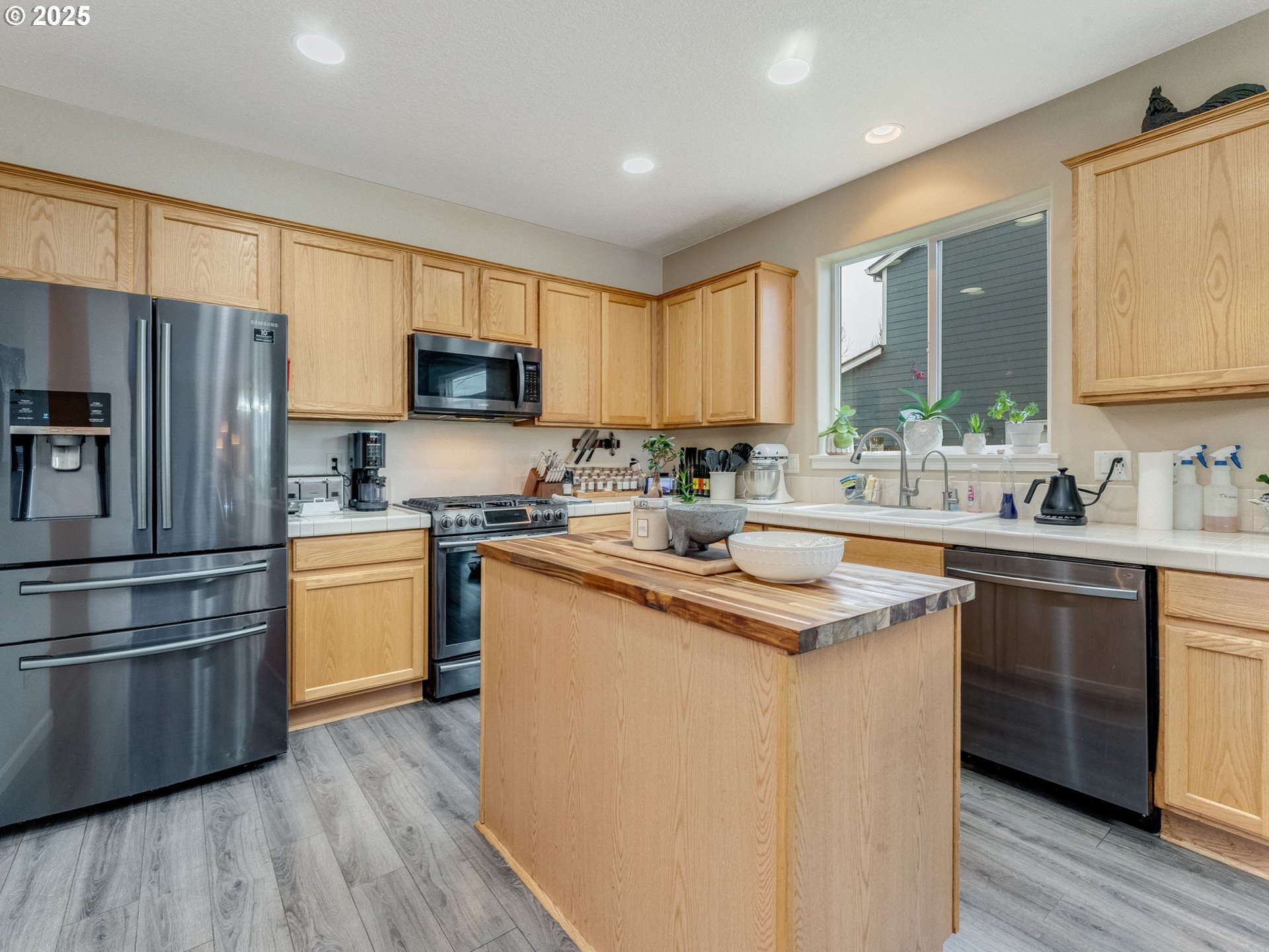 52144 Southeast 8th Street Scappoose, OR 97056 - Photo 18 of 48 a kitchen with stainless steel appliances granite countertop a sink stove and refrigerator
