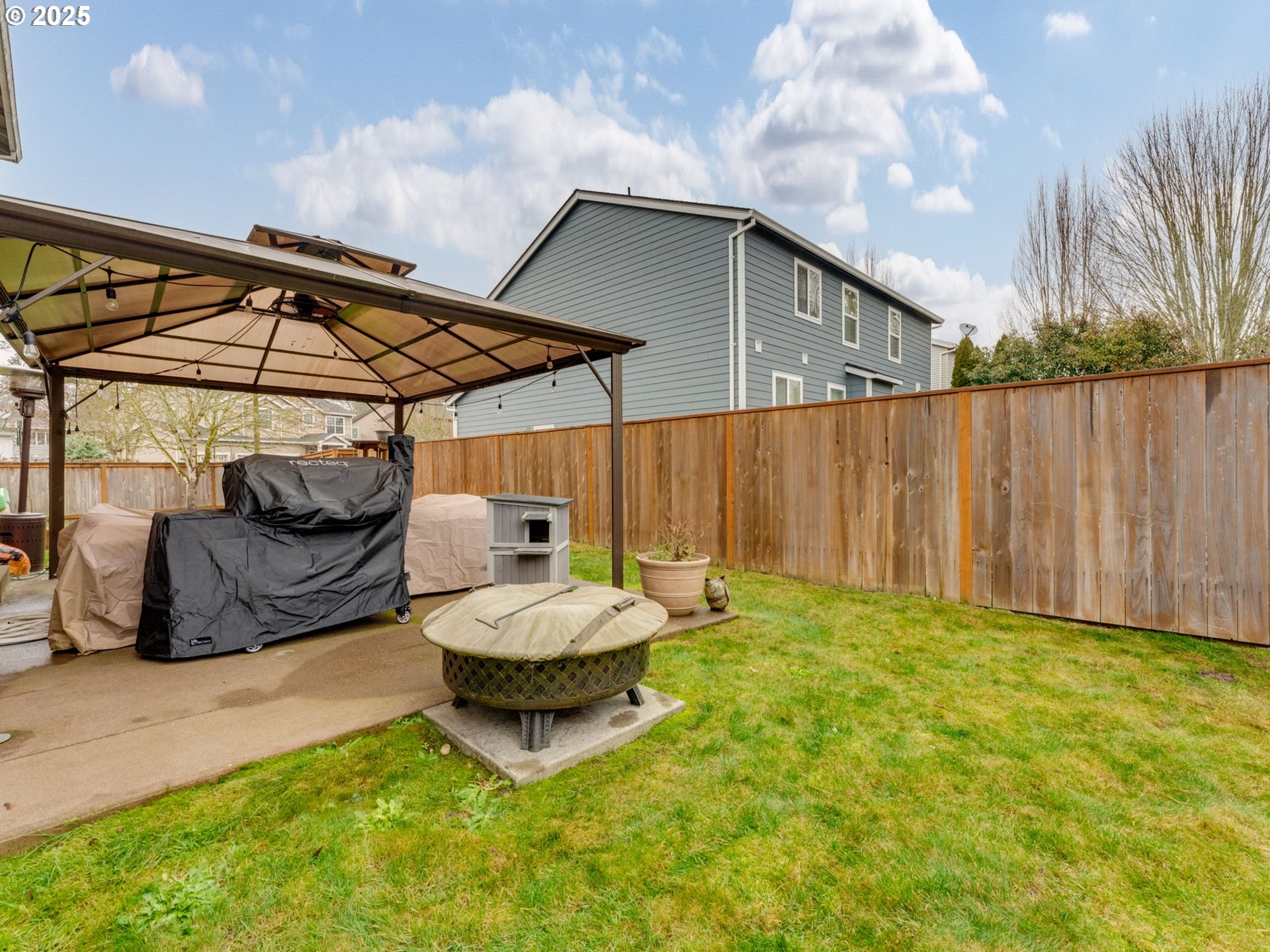 52144 Southeast 8th Street Scappoose, OR 97056 - Photo 39 of 48 a backyard of a house with barbeque oven table and chairs