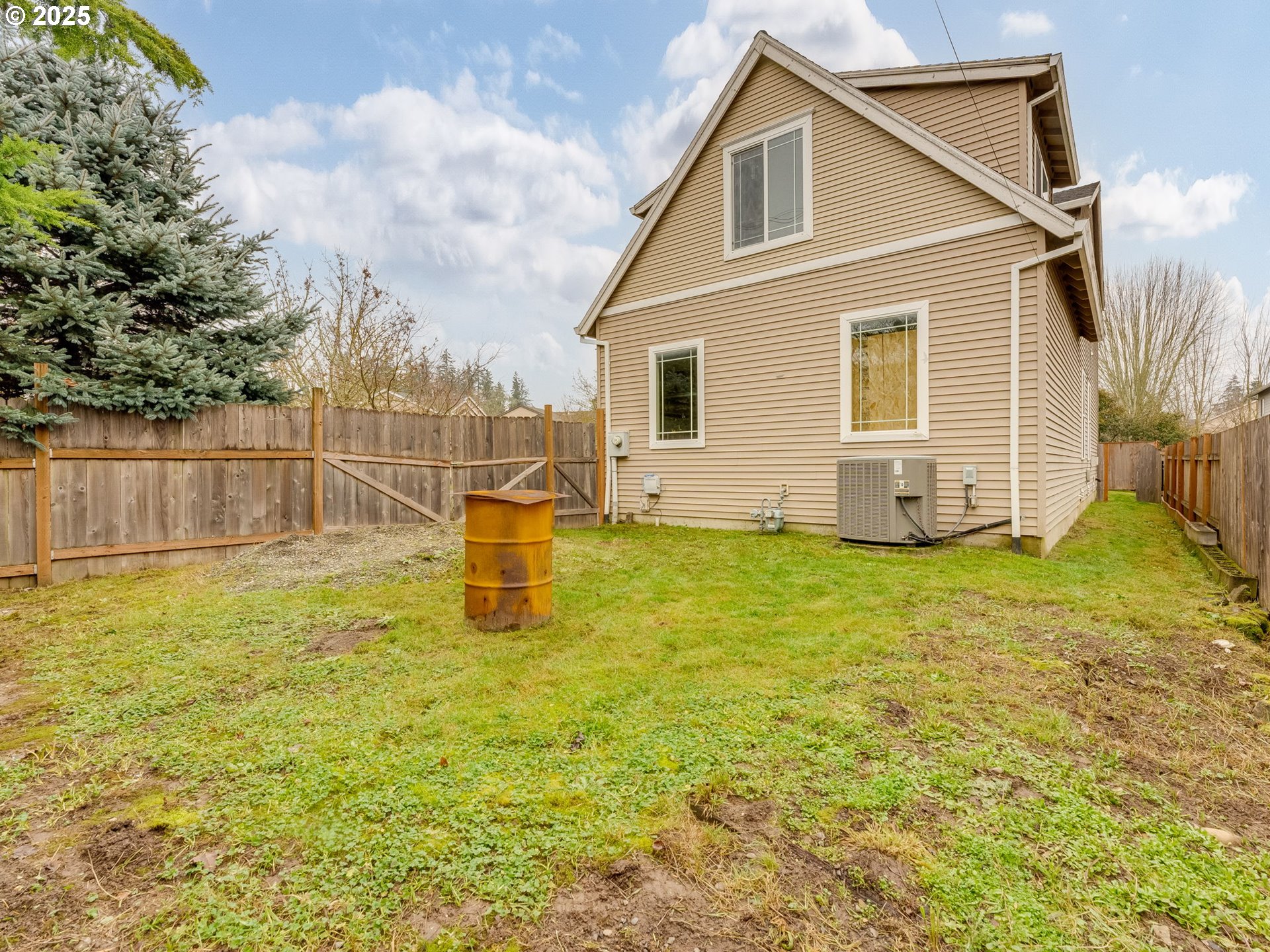 52144 Southeast 8th Street Scappoose, OR 97056 - Photo 46 of 48 a view of a backyard with table and chairs and wooden fence