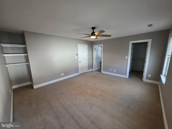 a view of an empty room with a fireplace