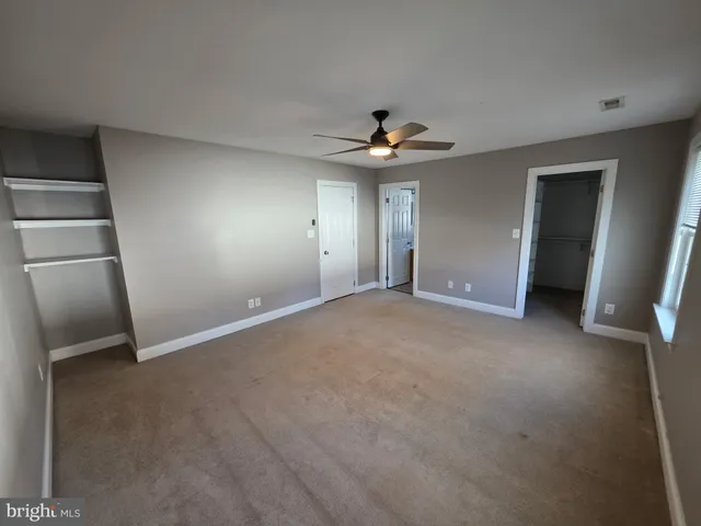 a view of an empty room with a fireplace