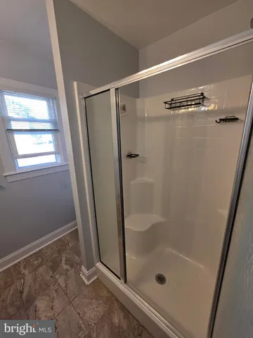 a bathroom with a glass shower door