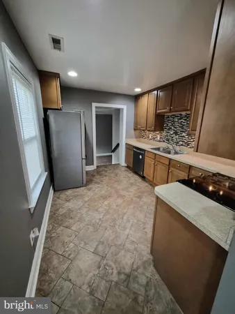 a kitchen with stainless steel appliances a refrigerator and a stove