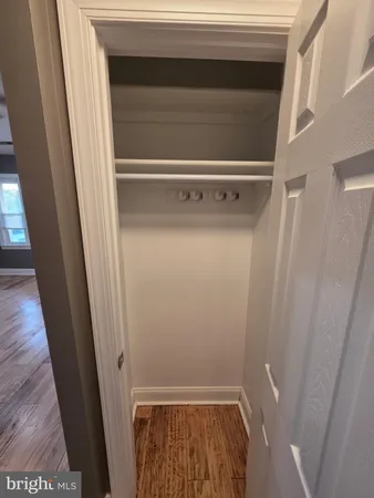 a view of walk in closet with wooden floor