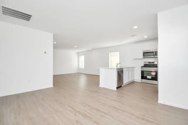 a view of kitchen with furniture and wooden floor