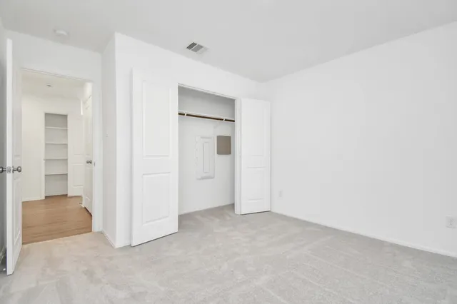 an empty room with closet area