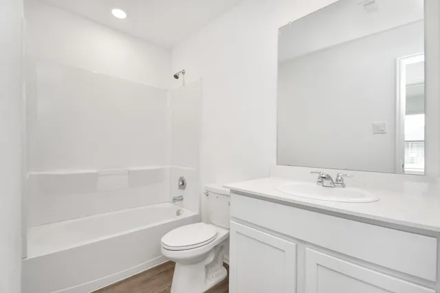 a bathroom with a sink a toilet and a bathtub