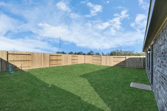 a view of yard with swimming pool and ocean view