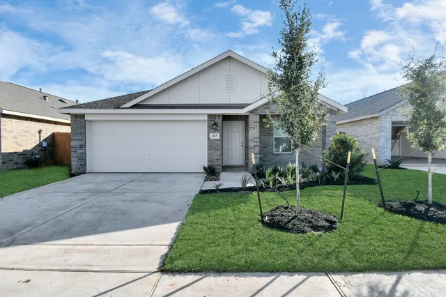 a front view of house with yard and green space
