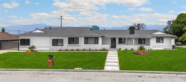 a front view of a house with a garden