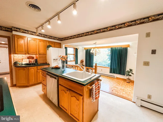 a kitchen with stainless steel appliances granite countertop a sink and a stove