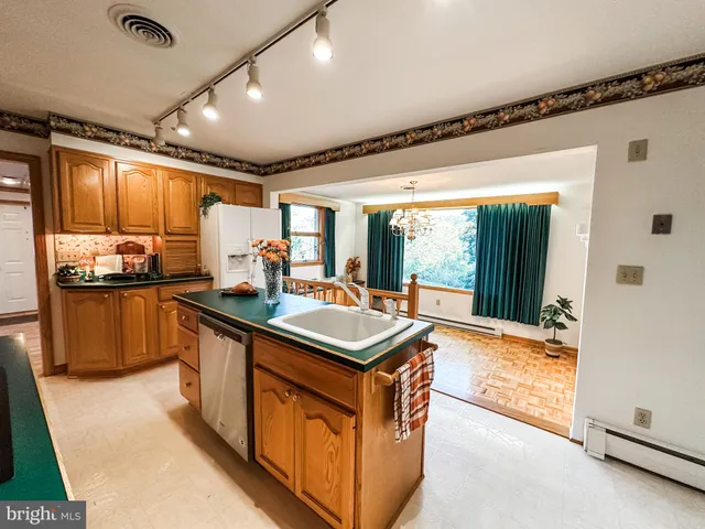 a kitchen with stainless steel appliances granite countertop a stove and a refrigerator